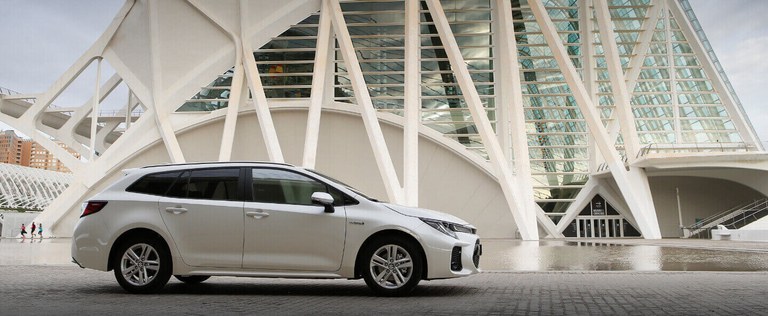 Seitlich fotografierter Suzuki Swace Hybrid in White Pearl Crystal Shine, Fokus auf dem Privacy Glass der hinteren Fenster.